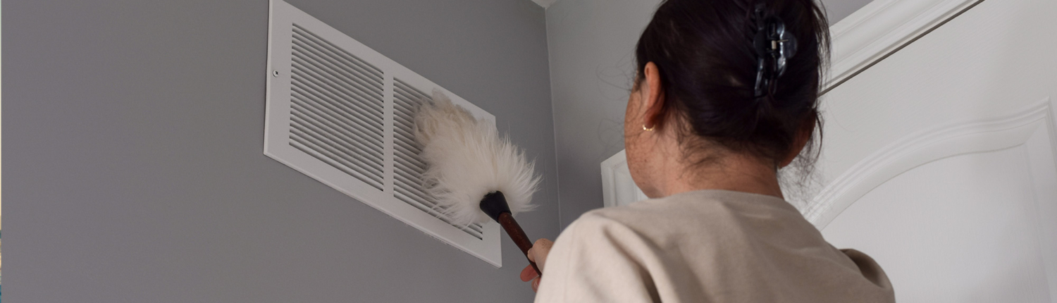 person cleaning ac