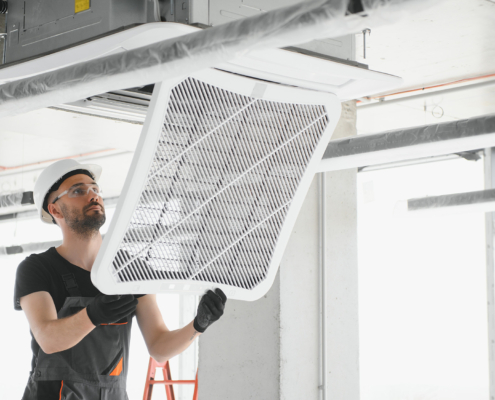 Worker installing a new filter in hvac system