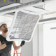 Worker installing a new filter in hvac system