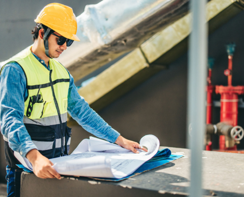 Worker looking over plans for HVAC upgrade