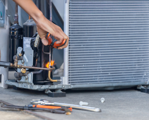 Close up of Air Conditioning Repair team use fuel gases and oxygen to weld or cut metals