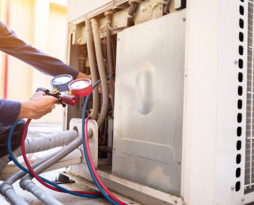 Technician is checking air conditioner ,measuring equipment for filling air conditioners
